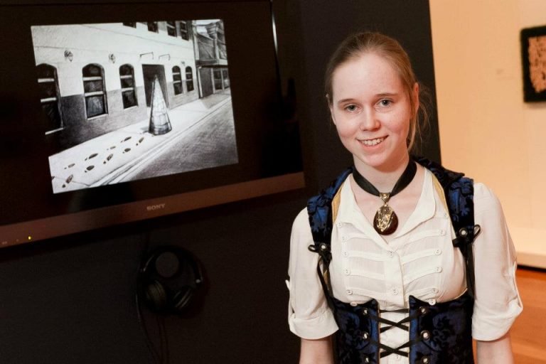 Photo of artist Lauren Edmonds with their work
