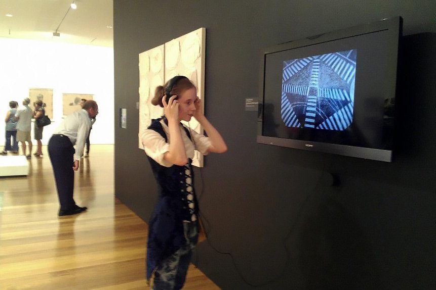 Photo of artist Lauren Edmonds with their work