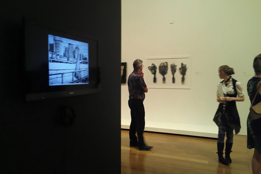 Photo of artist Lauren Edmonds with their work